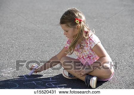 Young girl writing in chalk on the playground View Large Photo Image Stock Image - Young girl writing in chalk on the playground. Fotosearch