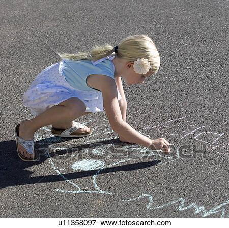 Young girl writing in chalk on the playground View Large Photo Image Stock Photo - Young girl writing in chalk on the playground. Fotosearch