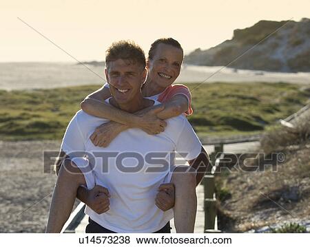 A mature couple walking on the coast View Large Photo Image Stock Photo - A mature couple walking on the coast. Fotosearch