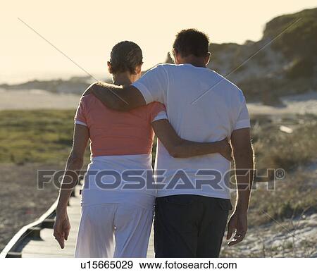 A mature couple walking on the coast View Large Photo Image Stock Photo - A mature couple walking on the coast. Fotosearch