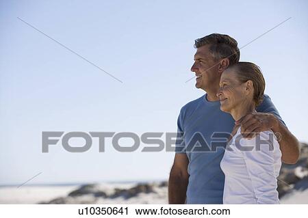 A mother and son standing on a beach View Large Photo Image Stock Image - A mother and son standing on a beach. Fotosearch