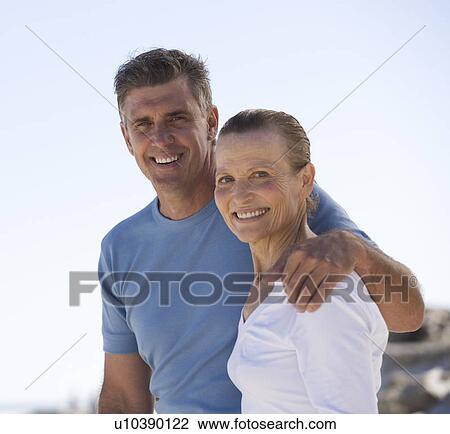 Stock Image - A mother and son standing on a beach. Fotosearch