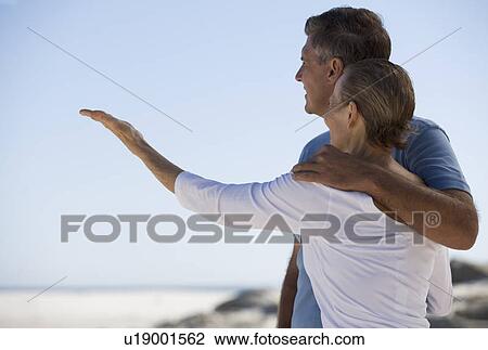 A mother and son standing on a beach View Large Photo Image Stock Image - A mother and son standing on a beach. Fotosearch
