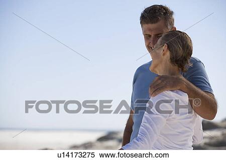 A mother and son standing on a beach View Large Photo Image Stock Photography - A mother and son standing on a beach. Fotosearch
