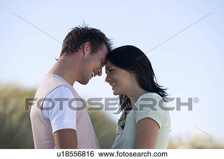 A young couple embracing in sand dunes, close-up View Large Photo Image Stock Photograph - A young couple embracing in sand dunes, close-up. Fotosearch