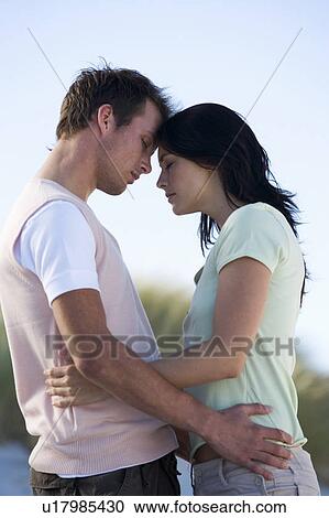 A young couple embracing View Large Photo Image Stock Image - A young couple embracing. Fotosearch