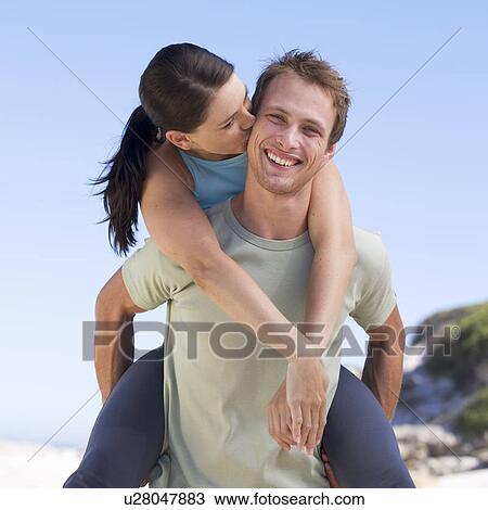 Portrait of a young couple, man giving woman piggyback View Large Photo Image Stock Image - Portrait of a young couple, man giving woman piggyback. Fotosearch