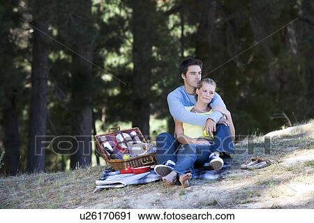 Stock Image - A young couple having a picnic. Fotosearch