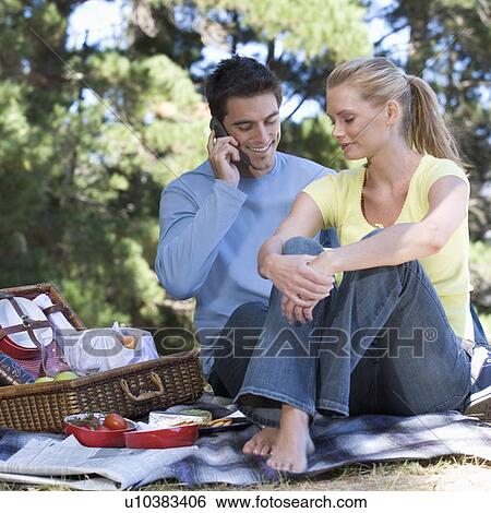 Stock Photograph - A young couple having a picnic. Fotosearch