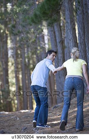 A young couple in a forest View Large Photo Image Picture - A young couple in a forest. Fotosearch