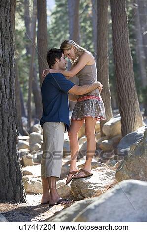 Picture - A young couple in a forest. Fotosearch