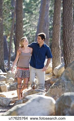 A young couple in a forest View Large Photo Image Picture - A young couple in a forest. Fotosearch