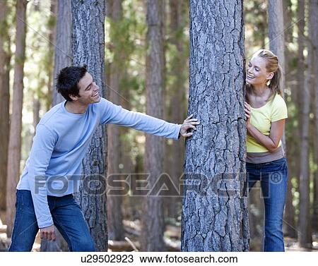 A young couple in a forest View Large Photo Image Stock Image - A young couple in a forest. Fotosearch