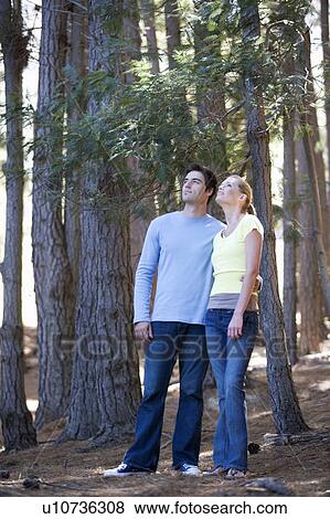 A young couple in a forest View Large Photo Image Stock Photo - A young couple in a forest. Fotosearch