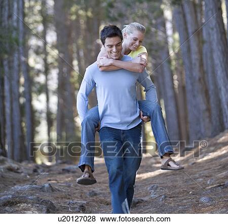 A young couple in a forest View Large Photo Image Stock Photo - A young couple in a forest. Fotosearch