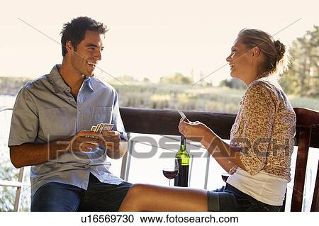 A young couple playing cards View Large Photo Image Stock Image - A young couple playing cards. Fotosearch