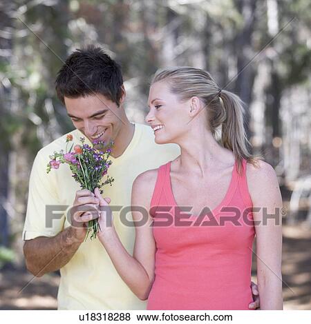 A young couple with a bouquet of flowers View Large Photo Image Stock Photo - A young couple with a bouquet of flowers. Fotosearch