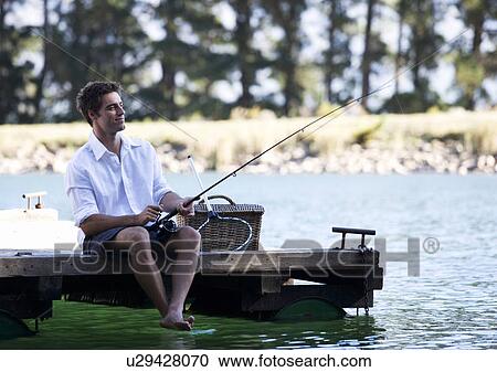 A young man fishing View Large Photo Image Stock Image - A young man fishing. Fotosearch