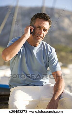 A man talking on a mobile phone View Large Photo Image Stock Image - A man talking on a mobile phone. Fotosearch