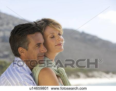 A mature couple on a beach View Large Photo Image Stock Image - A mature couple on a beach. Fotosearch