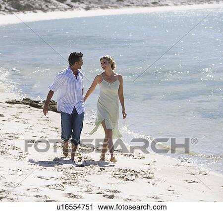 A mature couple on a beach View Large Photo Image Stock Image - A mature couple on a beach. Fotosearch