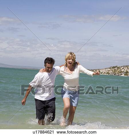 A mature couple on a beach View Large Photo Image Stock Image - A mature couple on a beach. Fotosearch