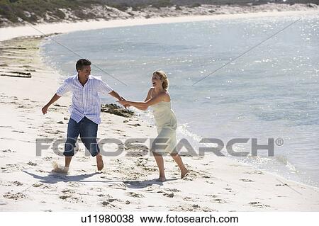 Stock Photo - A mature couple on a beach. Fotosearch