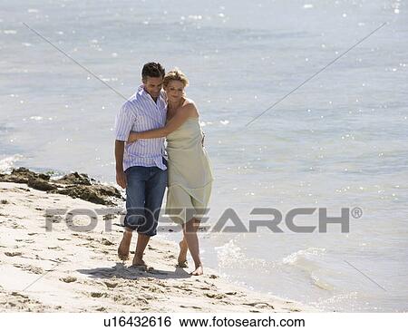 Stock Photograph - A mature couple on a beach. Fotosearch