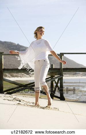 A woman dancing on a beach View Large Photo Image Stock Image - A woman dancing on a beach. Fotosearch