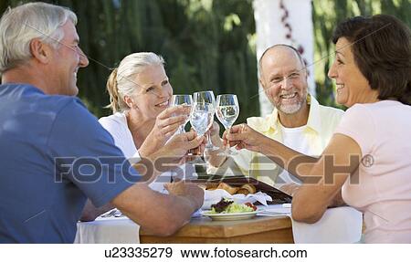 Stock Photo - A group of senior couples at a restaurant. Fotosearch