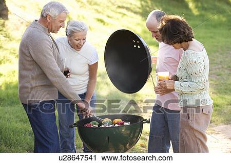 A group of senior friends having a barbeque View Large Photo Image Stock Image - A group of senior friends having a barbeque. Fotosearch