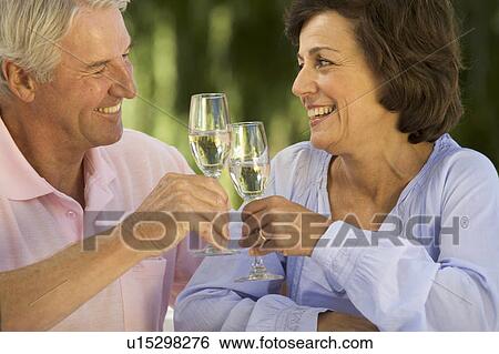 Stock Photograph - A senior couple celebrating. Fotosearch