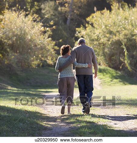 A senior couple walking View Large Photo Image Stock Image - A senior couple walking. Fotosearch
