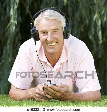 Stock Image - A senior man listening to music. Fotosearch