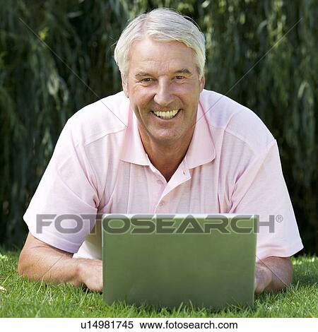 Stock Photography - A senior man using a laptop. Fotosearch