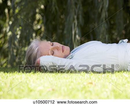 A senior woman asleep in the garden View Large Photo Image Stock Image - A senior woman asleep in the garden. Fotosearch