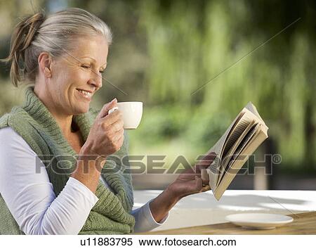 Stock Photography - A senior woman reading a book. Fotosearch