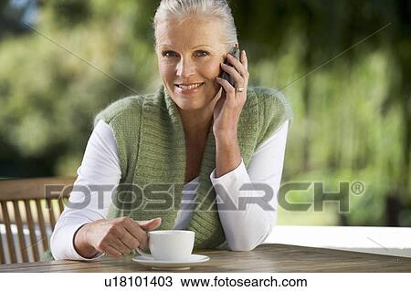 A senior woman talking on a mobile phone View Large Photo Image Stock Image - A senior woman talking on a mobile phone. Fotosearch