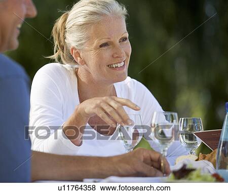 A senior woman with friends View Large Photo Image Stock Photo - A senior woman with friends. Fotosearch