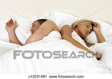 Young couple in bed, sleeping View Large Photo Image Stock Image - Young couple in bed, sleeping. Fotosearch