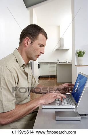 Young man working from home View Large Photo Image Picture - Young man working from home. Fotosearch