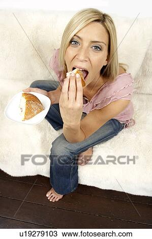 Young woman eating cake View Large Photo Image Stock Image - Young woman eating cake. Fotosearch