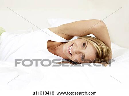 Young woman in bed View Large Photo Image Stock Photo - Young woman in bed. Fotosearch