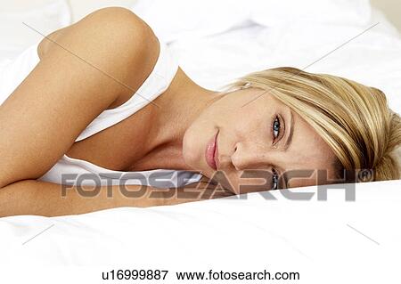 Young woman in bed View Large Photo Image Stock Photo - Young woman in bed. Fotosearch