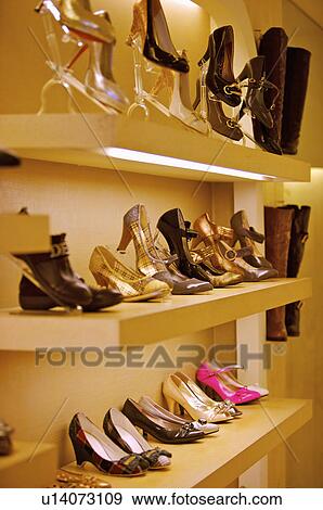 Different kinds of shoes showing on the shelf in the store, Shoe Store View Large Photo Image Stock Photo - Different kinds of shoes showing on the shelf in the store, Shoe Store. Fotosearch