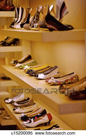 Stock Photography - Different kinds of shoes showing on the shelf in the store, Shoe Store. Fotosearch