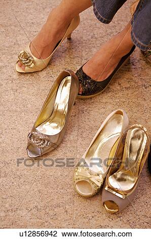 Stock Image - Woman trying on shoes in the shoe store, Shoe Store. Fotosearch