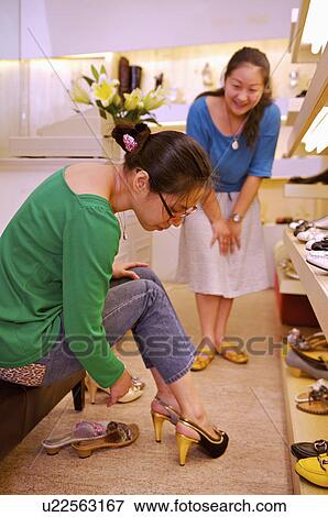 Woman trying shoes in the shoe store, Shoe Store View Large Photo Image Stock Photo - Woman trying shoes in the shoe store, Shoe Store. Fotosearch