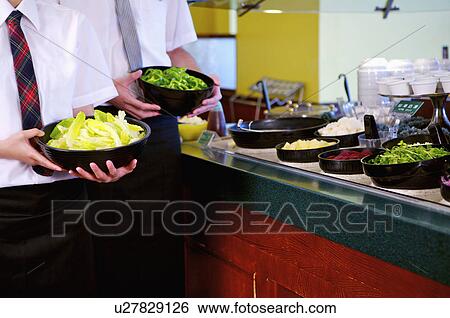 Young waiter and waitress seving dish in the restaurant, Restaurant View Large Photo Image Stock Photograph - Young waiter and waitress seving dish in the restaurant, Restaurant. Fotosearch