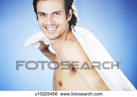 Stock Photograph - A young man using a towel. Fotosearch